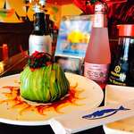 image for [I Ate] an Avocado Bomb: spicy tuna inside fresh crab inside avocado topped with seaweed salad and roe + Sriracha aioli.