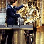 image for Mark Hamill and a black-tie wearing C-3PO at the 50th Academy Awards, accepting one of seven Oscars "Star Wars" won that night. (1978)