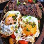 image for Steak and eggs over pan-fried potatoes with peppers and tomatoes [1080 × 1349]