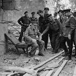 image for Winston Churchill sitting in the charred remains of Hitler's armchair, July 1945