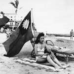 image for Ruth Lee, a hostess at a Chinese restaurant, flies a Chinese flag so she isn’t mistaken for Japanese when she sunbathes on her days off in Miami, in the wake of the attack on Pearl Harbor, Dec. 15, 1941 [2998 × 2392]