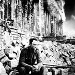 image for German soldier takes a break from the combat during the Battle of Berlin as the Reichstag burns behind him, April 1945[1024x1500]