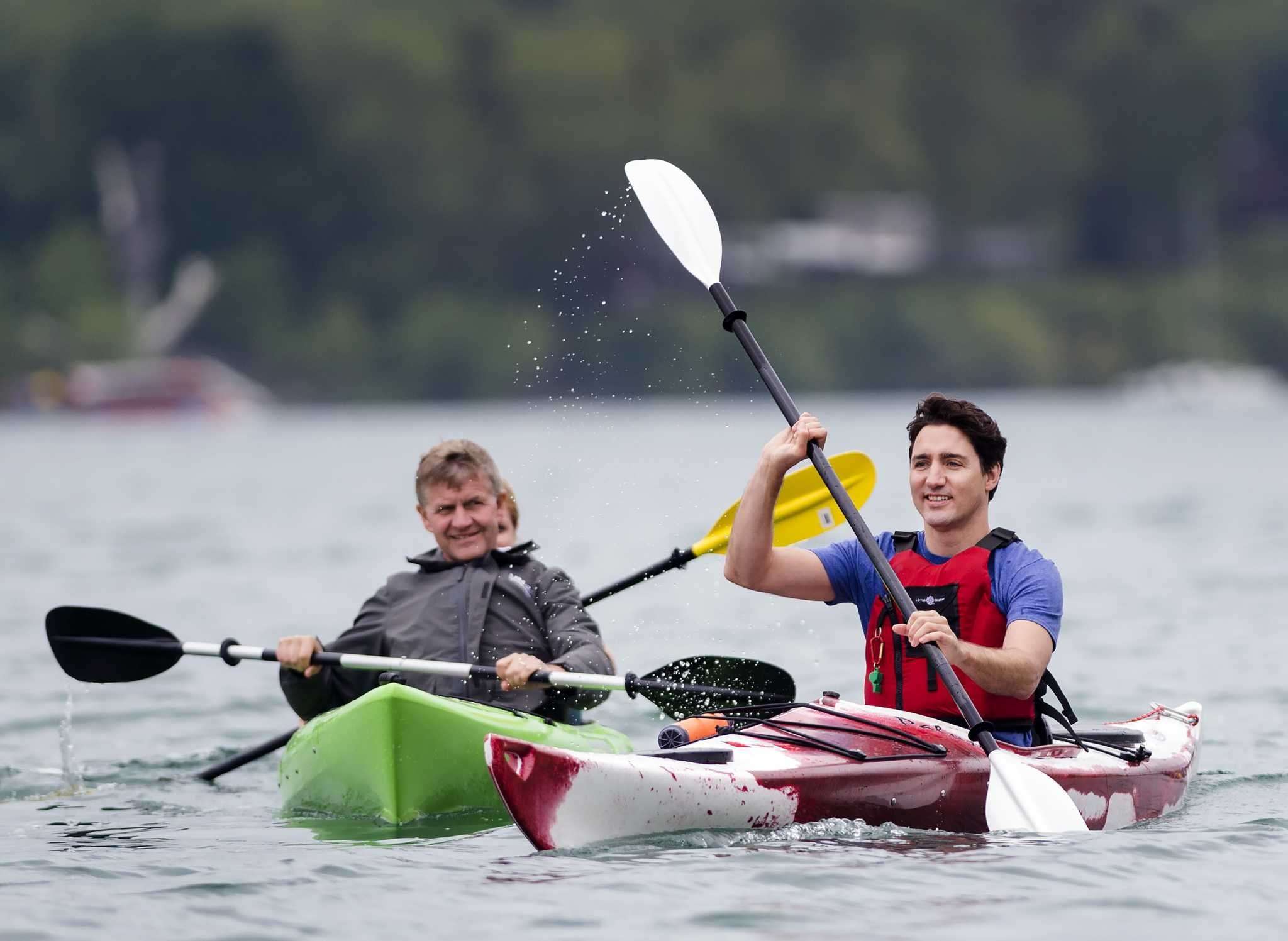 image for Canadian Prime Minister Justin Trudeau kayaks over to a family to discuss climate change