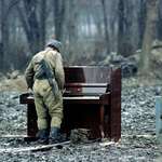 image for Russian soldier playing an abandoned piano in Chechnya