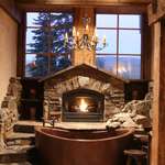image for Copper Tub nestled in the Hearth of a Massive Stone Fireplace w/ built-in Waterfall | Lake Tahoe, CA [2336 x 3504]