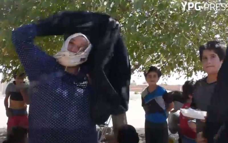 image for Women burn burqas and men shave beards to celebrate liberation from Isis in Syria