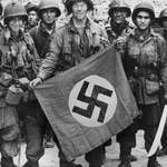 image for Real Americans displaying the Nazi flag -- after capturing it from Nazis they killed, 1944