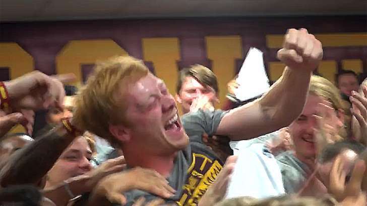image for College football player who helps kids in need surprised with scholarship