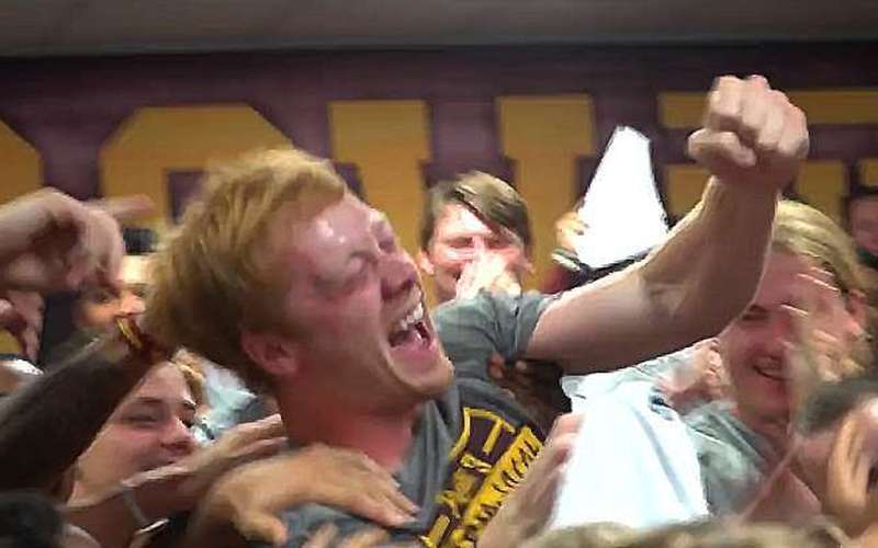 image for College football player who helps kids in need surprised with scholarship