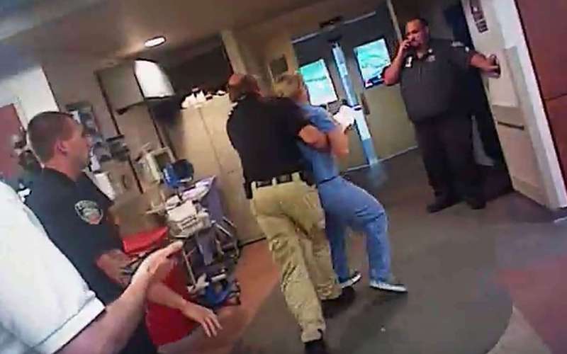 image for The Latest: Officer who arrested Utah nurse put on leave