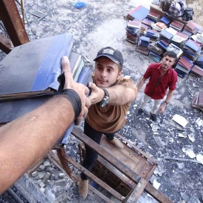 image for Volunteers rescue thousands of books from Mosul library destroyed by Islamic State