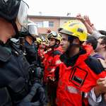 image for Firemen form a human shield to protect voters from riot police in Catalunya.