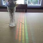 image for This spectrum reflected off the dining room window through a chair back.