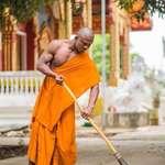 image for PsBattle: A muscle-ridden Monk sweeping a sidewalk.