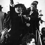 image for Lyndon B. Johnson yelling at the pilots of a nearby plane to cut their engines so that John F. Kennedy could speak as JFK is trying to calm him down during the 1960 presidential campaign in Texas.