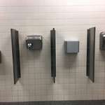 image for This airport restroom has four different hand dryers.