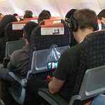 image for This genius watching Taken using a clear plastic bag to hold his phone on a plane.