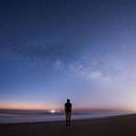 image for I photographed myself looking at the Milky Way just before sunrise over the Atlantic Ocean.