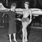 image for A Scandinavian Stewardess examines a new uniform proposal for Scandinavian Airlines in 1964. It was not approved.