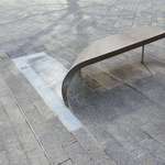 image for This bench is made from a curled-up paving stone.