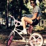 image for Cut-off t-shirt, short-shorts, pink mag wheels and a mullet (1985)
