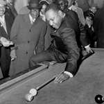 image for Martin Luther King Jr. making a behind-the-back pool shot during a visit to a pool hall in Chicago, 1966