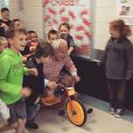 image for My dad challenged the students at the school where he is the principal to read a combined 1,000 minutes. The reward would be getting to push him down the hall on a tricycle while he wore mismatched clothes inside out.