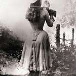 image for Sharpshooter Annie Oakley shooting over her shoulder using a hand mirror, circa 1899.
