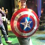 image for Paul Rudd holding this Captain America shield signed by all the MCU stars. It sold for $53,000 with 100% of the proceeds going to the Children's Mercy Hospital in Kansas City.