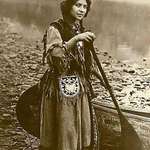 image for 1908 Native American woman. From the canoe to the clothes to her look, it’s all cool