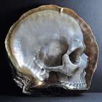 image for Filipino artist, Gregory Halili, carves intricate skulls into mother of pearl shells.