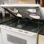 image for Most electric coil stove tops lift up to clean underneath