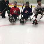 image for Just over three months after the bus crash that killed 16 hockey players in Saskatchewan, survivor Ryan Straschnitzki (left), who suffered a spinal injury, is practicing sledge hockey. He hopes to one day participate in the Paralympic Games.