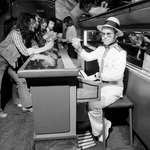 image for Elton John travelling on his a private jet, complete with a piano bar, 1974