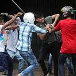 image for A reporter in Bangladesh gets beaten with metal rods in an attempt to destroy his camera. This picture was taken within the last hour.