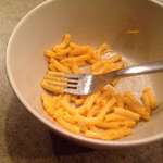 image for Eating Mac n' Cheese by arranging a single noodle on each fork tine.