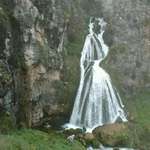 image for This waterfall looks like a woman in a dress.