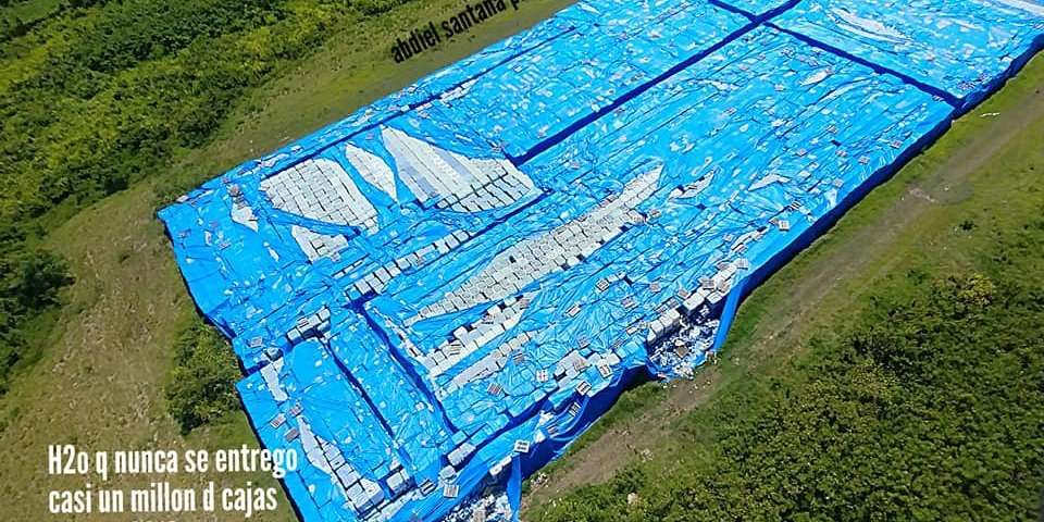 image for Photos reportedly show massive stockpile of bottled water left on a runway for more than a year in Puerto Rico after Hurricane Maria