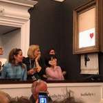 image for Banksy's "Girl with Balloon" shreds itself after being sold for over £1M at the Sotheby's in London.