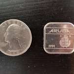 image for The 50¢ piece in Aruba is square. Quarter for scale