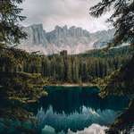 image for Calm water and jagged mountains. Reflections at Lago di Carezza, Italy. [OC][3747×4684]