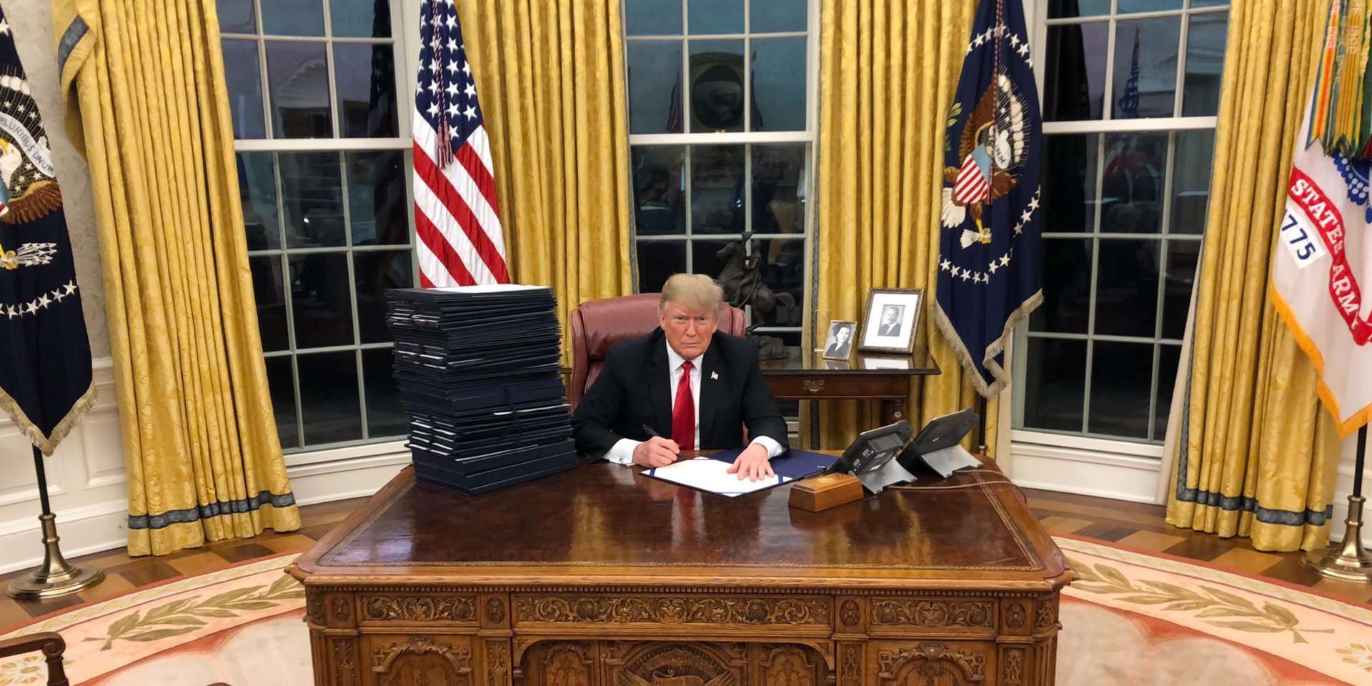 image for Trump tweeted a picture of himself signing a 'bill' that appears to be a blank sheet of paper, and the internet is having a field day