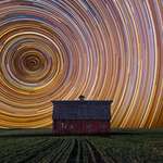 image for Long exposure of star trails against a farmhouse