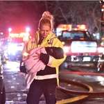 image for EMT carrying a puppy from a house fire last night
