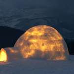 image for This is what an Igloo looks like when you build a fire inside. The fire inside melts the inner layer of ice, and the cold outside refreezes it adding a layer of insulation that can keep the igloo at 60° inside while it's -50° outside.