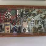 image for Holocaust shadowbox. My great grandfather took a souvenir from every Nazi he killed and made this display with the items. It even includes a piece of Hitler’s carpet.