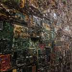 image for A wall completely covered in motherboards, etc