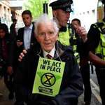 image for An 83 year old climate change protester being arrested in London today after he climbed on top of a DLR train.