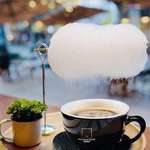 image for This coffee is served with a cloud of "cotton candy", the coffee vapor rises to dissolve the "cotton candy" and the cloud begins to rain with sugar over the coffee. Coffee "mellow" in Shanghai, China.