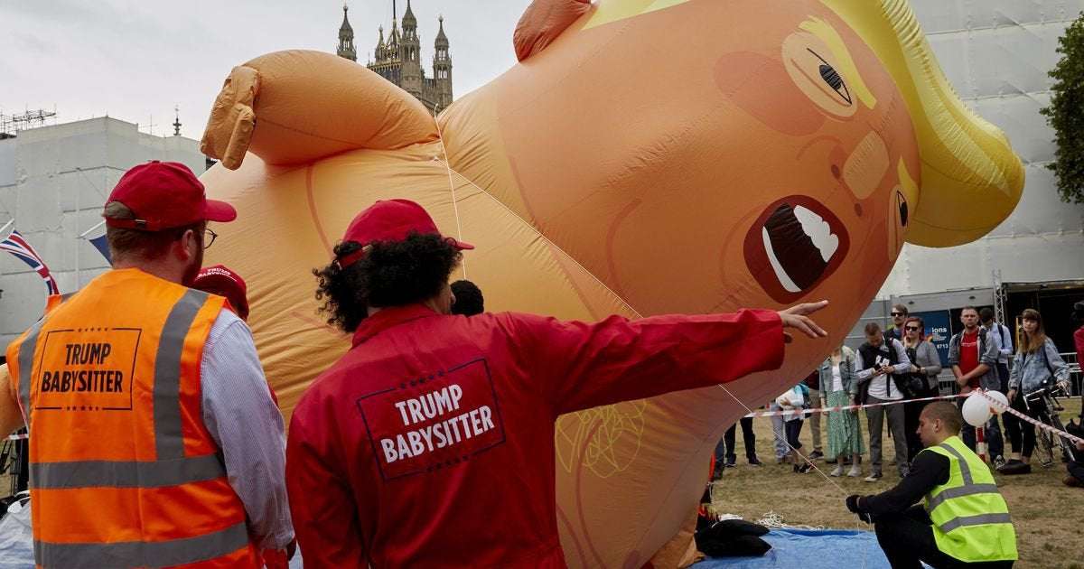 image for Trump supporter stabs giant Trump baby blimp — and cuts herself in the process